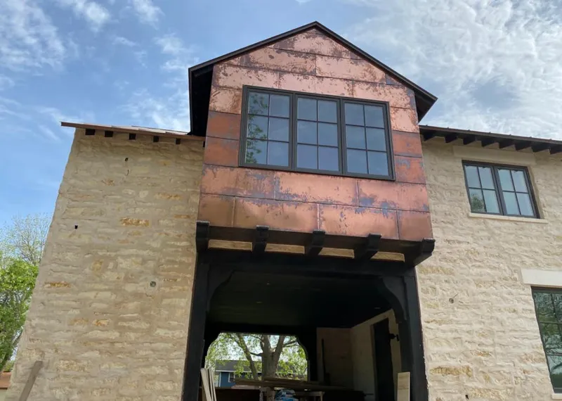 Copper metal panel facade on a stone building for Skylight Installation in Valle Vista