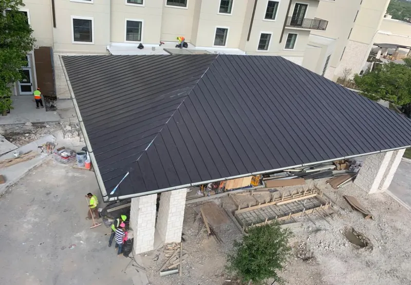 Metal roofing installation team working on a commercial building in Valle Vista